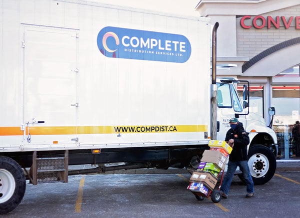 A Complete Distribution truck makes a direct store delivery